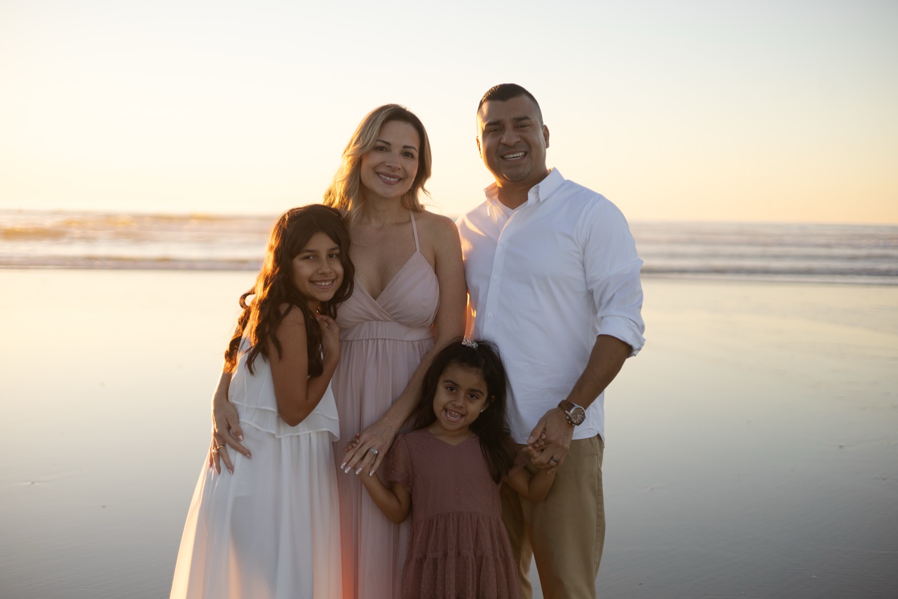 Family portrait on the beach at sunset