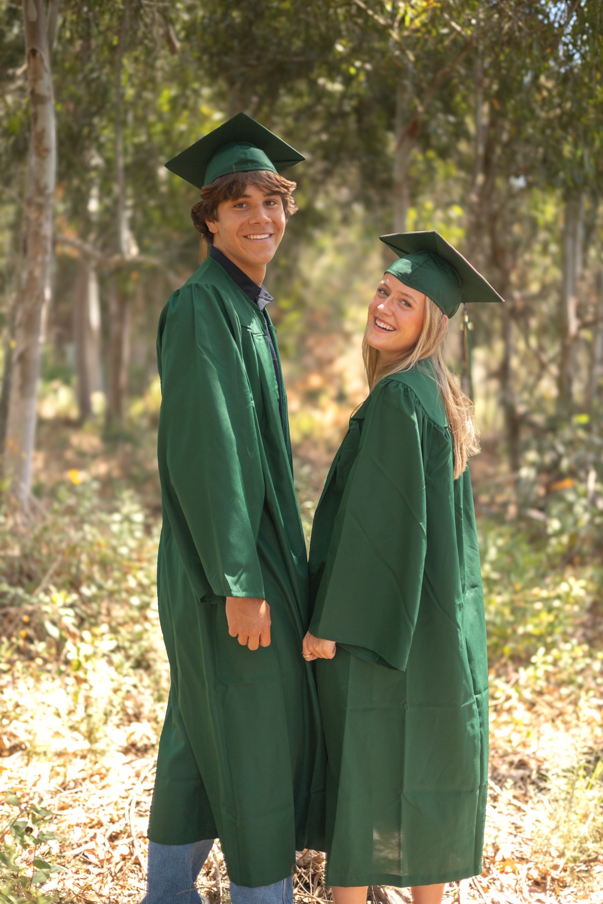 Couple in green caps and gowns